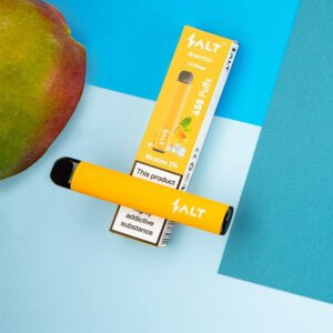 A slice of mango withm with a mango vape on the box